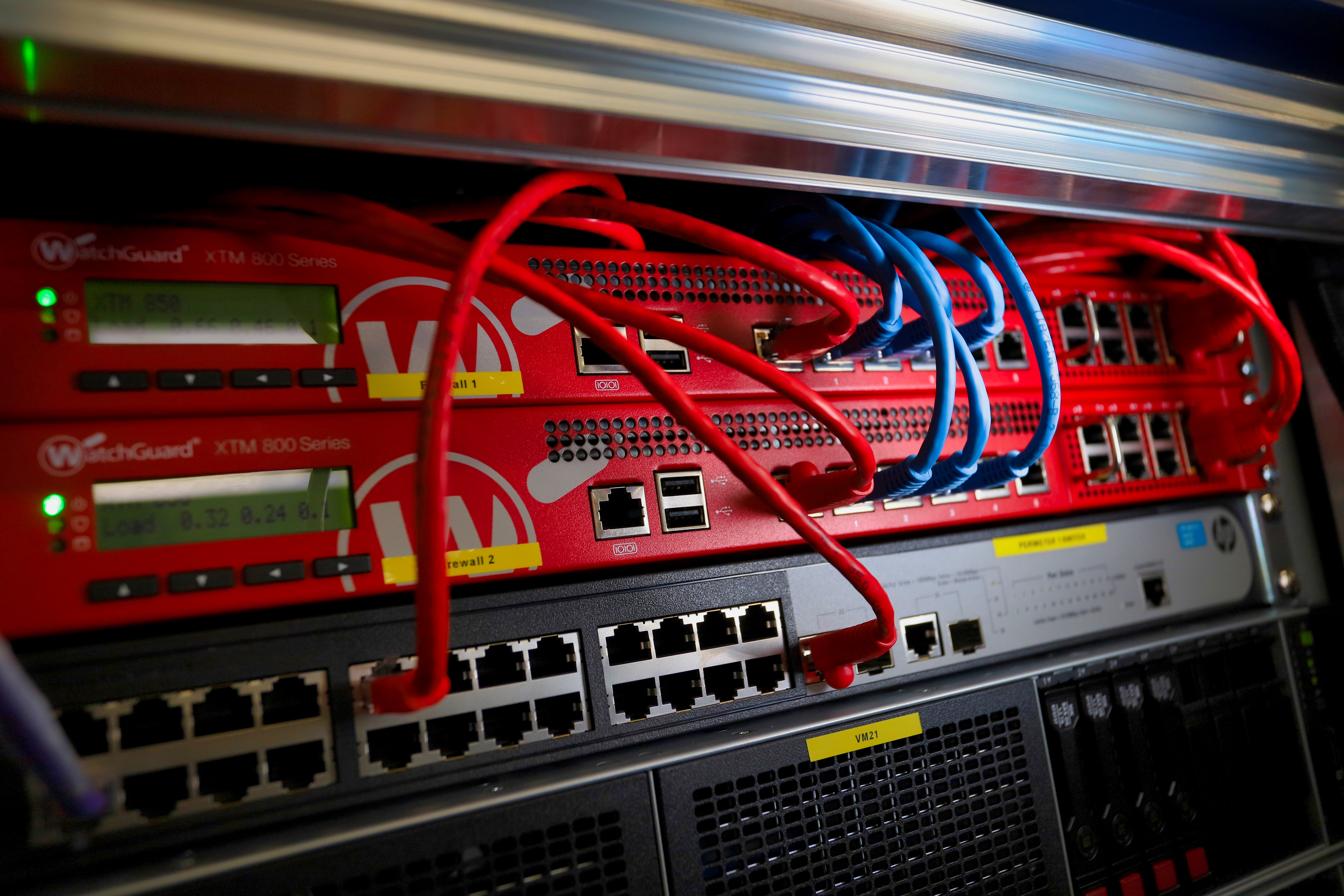A server rack densely packed with various cables and wires, illustrating a high-tech data center environment.